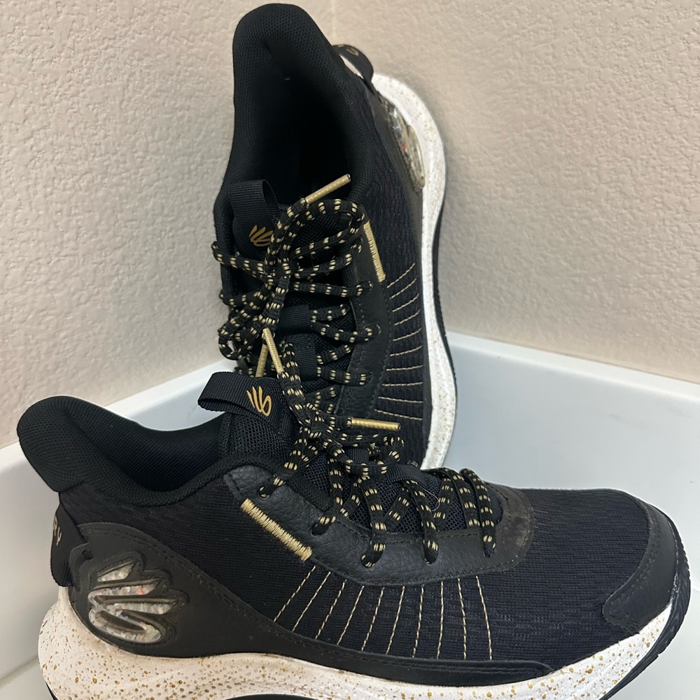 Under Armour Curry’s Black and Gold Athletic Sneakers